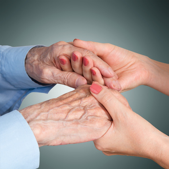 holding a senior citizen's hands